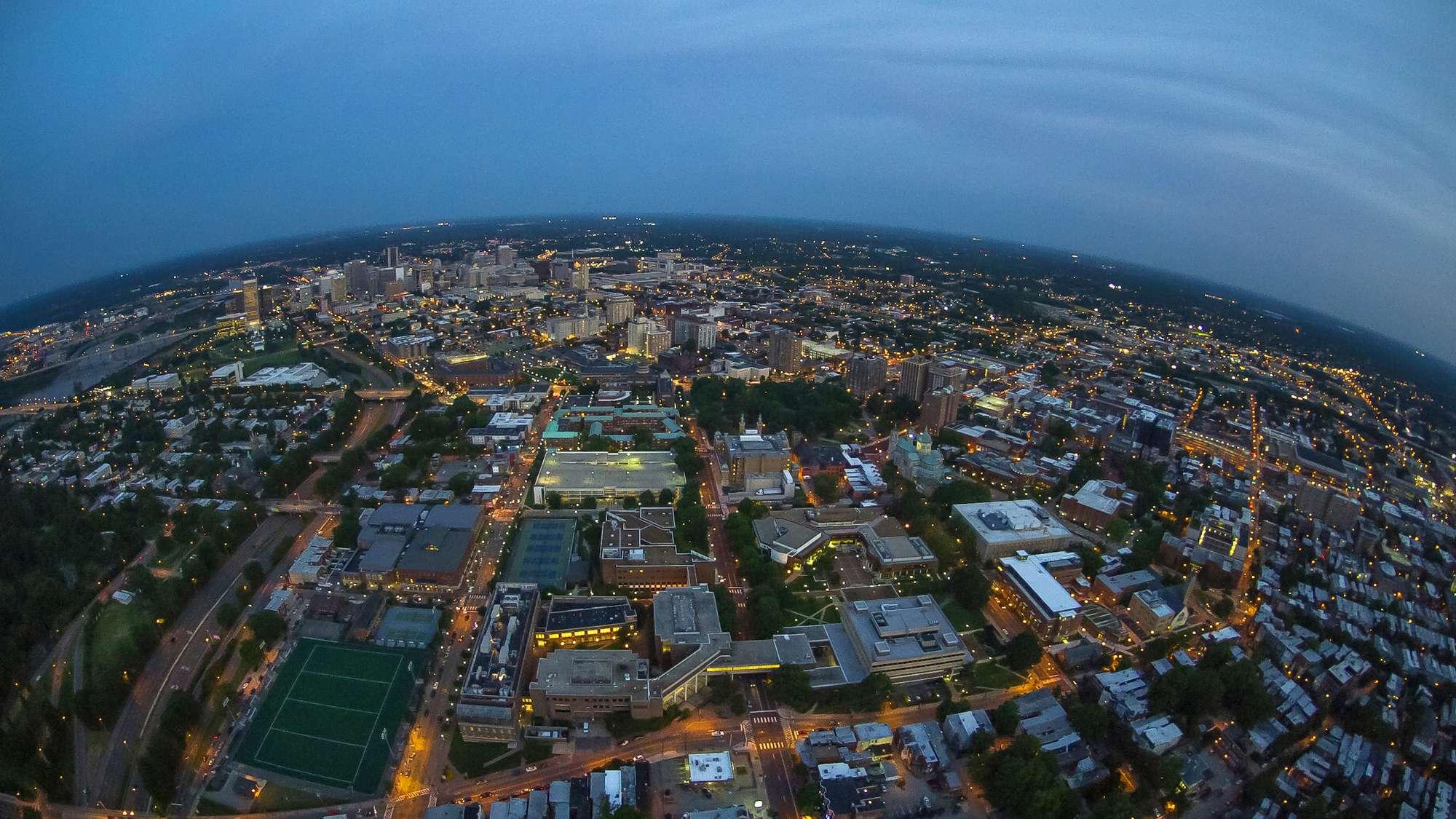 Photo showing an aerial view of VCU and the Richmond, Virginia city skyline at night